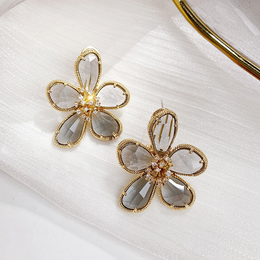 Aretes Rotativos Flor de la Riqueza con Circonitas Incrustadas